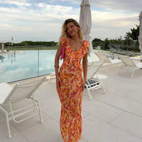 Estiloso vestido bohemio de fiesta con escote en V y volantes en las mangas | Midi