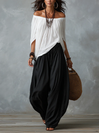 Elegante conjunto de mujer blanco con top de hombros descubiertos y pantalón ancho